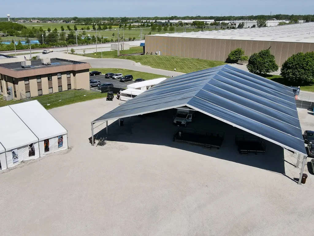 Large clearspan structure set up for a beer festival with open sides and gravel flooring.