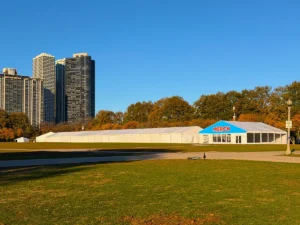 A long clearspan tent with a bright blue “MERCH” sign set up in downtown Chicago for the Hot Chocolate Run, installed by JK Rentals.