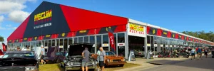 Mecum Auctions clearspan structure with glass walls and branded red and black fascia