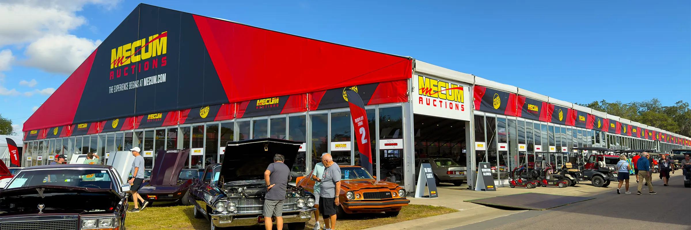 Mecum Auctions clearspan structure with glass walls and branded red and black fascia
